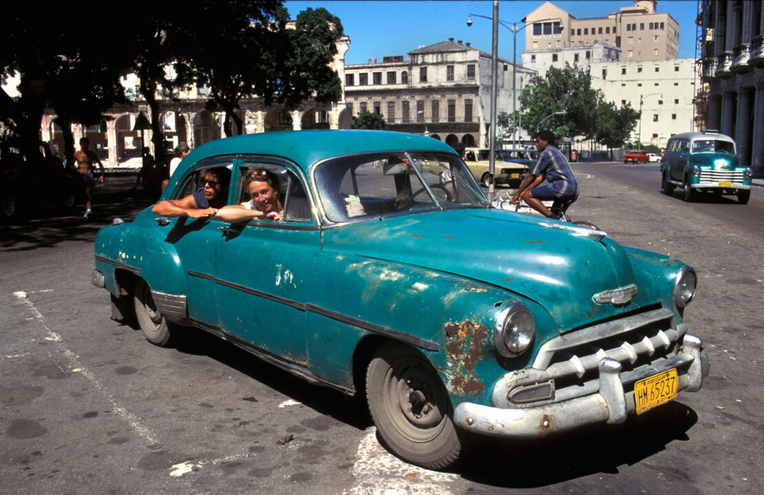 Tourists in an old car, Havana Cuba.